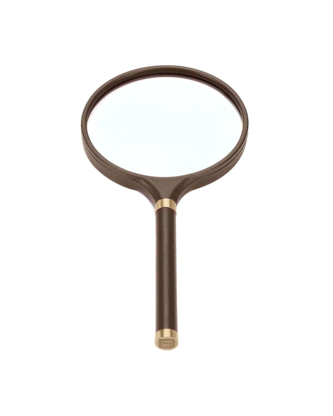 ASSOULINE archival magnifying glass in brown pebbled leather. Refined desk accessory for modern interiors.
